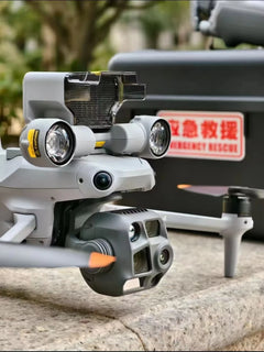 DJI Matrice 4T camera and mounted lights beside an emergency rescue label