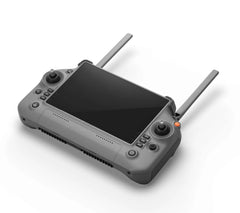 DJI RC Plus controller lying at an angle with screen and joysticks visible