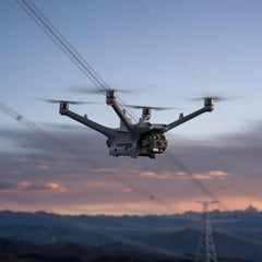 DJI Matrice 4TD flying beside power lines at dusk